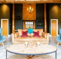 A living room with a sofa and chairs at Bears Den in Addingham