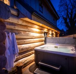 An outdoor area with a hot tub and robes at Bears Den in Addingham