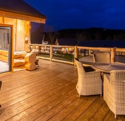 An outdoor deck with a table and chairs at Bears Den in Addingham