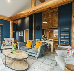 A living room with a coffee table and dining area at The Farmhouse in Addingham