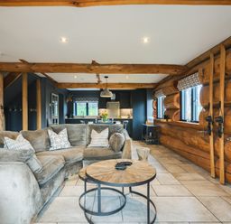 A living room with a sofa and television at Apres Ski in Addingham