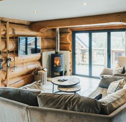 A living room with a fireplace and a sofa at Apres Ski in Addingham