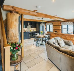 A living room featuring a sofa and dining area at Apres Ski in Addingham