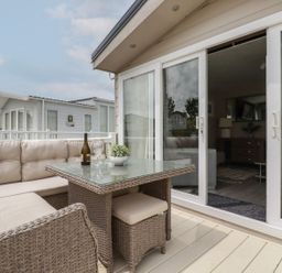 An outdoor seating area with a sofa and table at No. 4 Fistral in Newquay