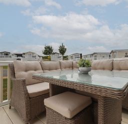 An outdoor seating area with a table and couch at No. 4 Fistral Newquay