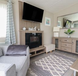A living room with a television and a sofa at No. 4 Fistral in Newquay
