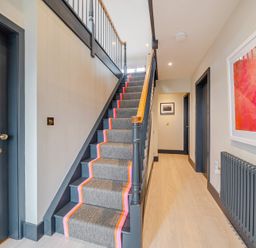 A staircase in a hallway at Bell House Llanfechell