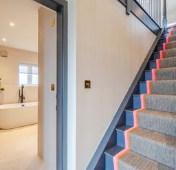 A hallway with a staircase and a bathtub visible at Bell House in Llanfechell