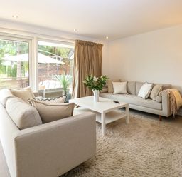 A living room with sofas, a coffee table, and a television at Three Ways South Lopham near Garboldisham