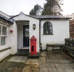 An entrance with a red post box and stone wall at Newlands Fell House near Keswick