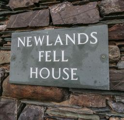 A stone sign displaying Newlands Fell House at Newlands near Keswick