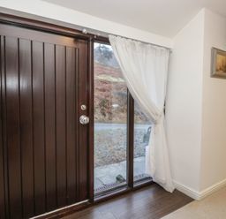 An entrance with a front door and window at Newlands Fell House in Newlands near Keswick