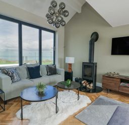 A living room with a sofa and a television at Pengarnedd in Amlwch