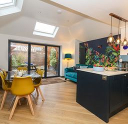 A kitchen with dining table and chairs at Still Waters in Weymouth