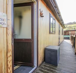 An entrance area of Hazel Lodge in Clunton near Clun with a wooden door and walkway