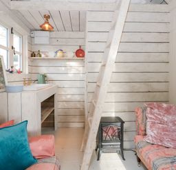 A living room with a staircase and a sink at Shades Farm Cabin in Circenester