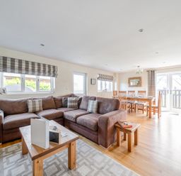 A living room with a sofa and dining area at James Ville Marina Lodge 7 Brigg
