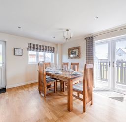 A dining room with a table and chairs at James Ville Marina Lodge 7 in Brigg