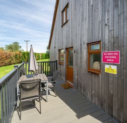 An outdoor decking area with table and chairs at James Ville Marina Lodge 8 in Brigg