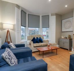 A living room with a sofa and armchairs at South Villa Sandsend near Whitby