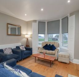 A living room with a sofa and coffee table at South Villa in Sandsend near Whitby