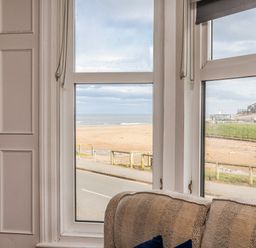 A living room with a beach view at South Villa Sandsend near Whitby