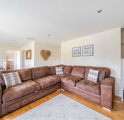 A living room with a sofa and dining area at James Ville Marina Lodge 9 in Brigg