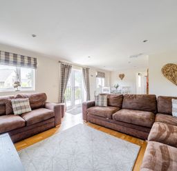 A living room with a sofa and dining area at James Ville Marina Lodge 9 in Brigg