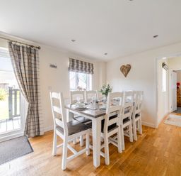 A dining room with a table and chairs at James Ville Marina Lodge 9 in Brigg