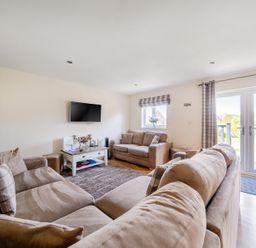 A living room with a television and a sofa at James Ville Marina Lodge 13 in Brigg
