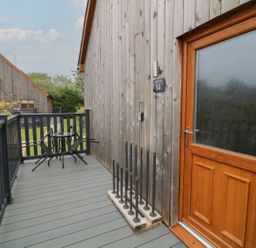 An outdoor area with a wooden door and seating at James Ville Marina Lodge 14, Brigg