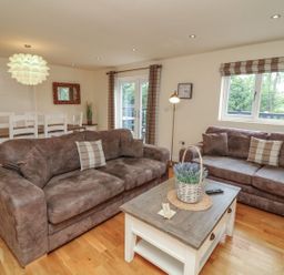 A living room with sofas and a dining area at James Ville Marina Lodge 14 in Brigg