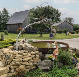 A garden with a sculpture and pond at James Ville Marina Lodge 21 in Brigg