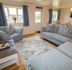 A living room with sofas and a coffee table at James Ville Marina Lodge 21 in Brigg