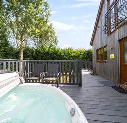 An outdoor area with a hot tub and chairs at James Ville Marina Lodge 10 in Brigg