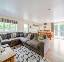 A living room with a sofa and dining area at James Ville Marina Lodge 10 in Brigg