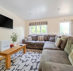 A living room with a sofa and coffee table at James Ville Marina Lodge 10, Brigg