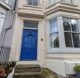 A front door with a blue color and steps at Apartment 3 in Scarborough