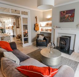 A living room with a sofa and fireplace at The Secret Garden in Narberth