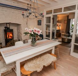 A dining room with a table and chairs at The Secret Garden in Narberth
