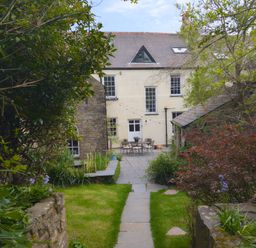 A garden with a house in the background at The Secret Garden in Narberth