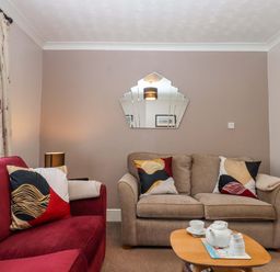 A living room with a sofa and coffee table at 16 Elmbank Gardens in Paignton