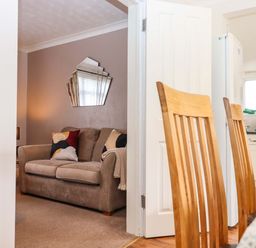 A dining room with a view into a living room at 16 Elmbank Gardens Paignton