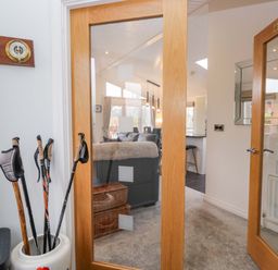 An entrance hall with walking poles and clocks at Waters Edge Lodge in Windermere