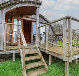 A wooden cabin with steps and deck at Vine View near Halesworth
