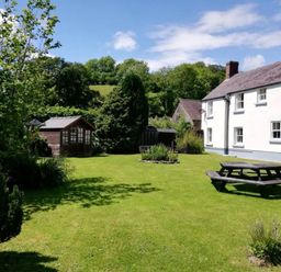 A garden with a picnic table and a shed at Picton House near St Clears