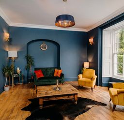 A living room with seating and a coffee table at Picton House near St Clears