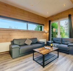 A living room with sofas and a coffee table at Poplar Lodge (Pet) Thirsk