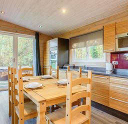 A kitchen with a dining table and chairs at Poplar Lodge (Pet) Thirsk