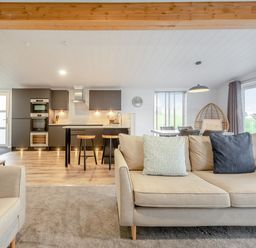 A living room and kitchen area with furniture at Sonnet 3 Spa in Carmarthen